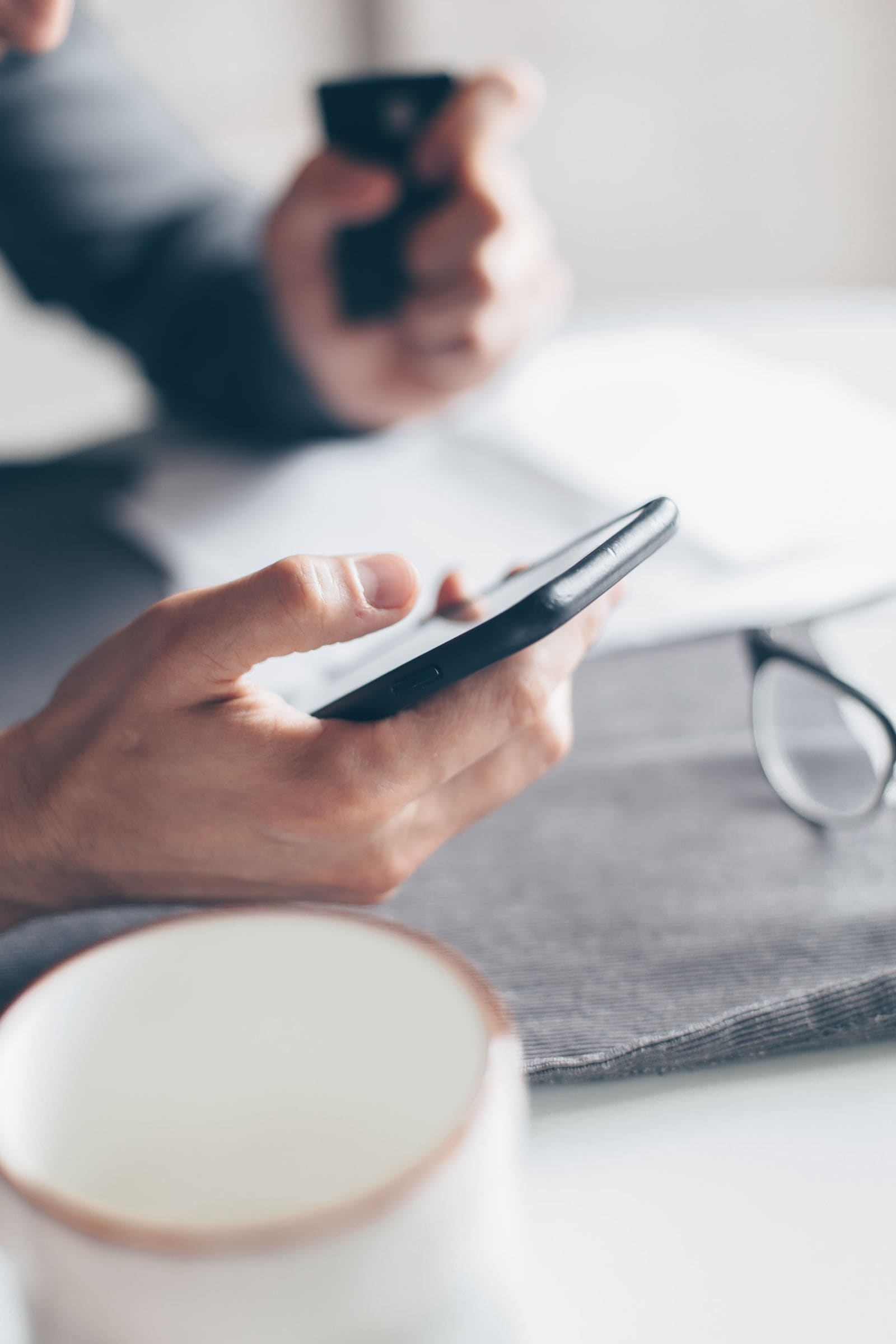Mãos segurando celular e cartão durante um pagamento digital